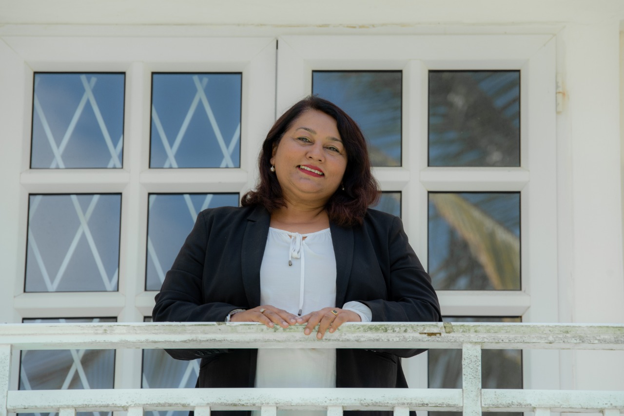 Me Mokshda Pertaub standing on an outdoor balcony