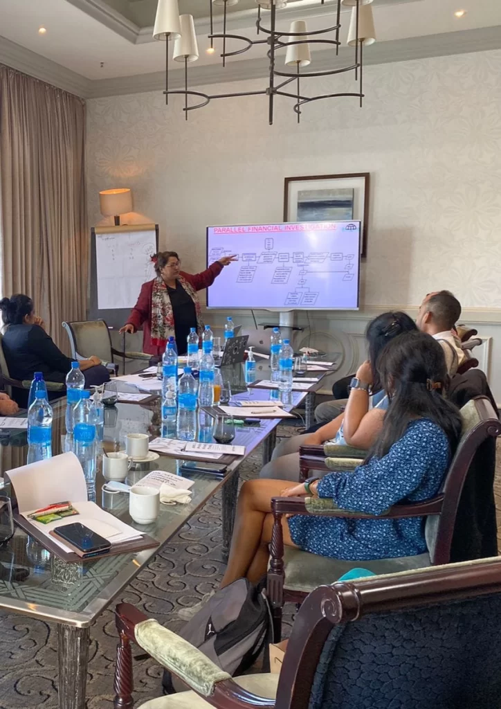 Me Mokshda Pertaub presenting a financial-investigation training session to seated participants