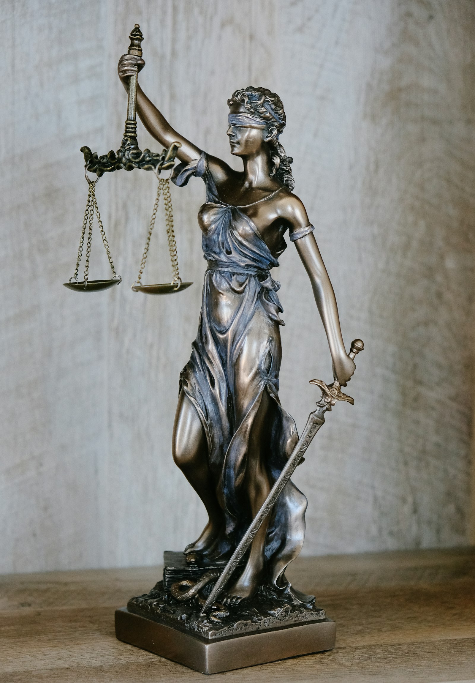 Bronze statue of Lady Justice holding scales and a sword
