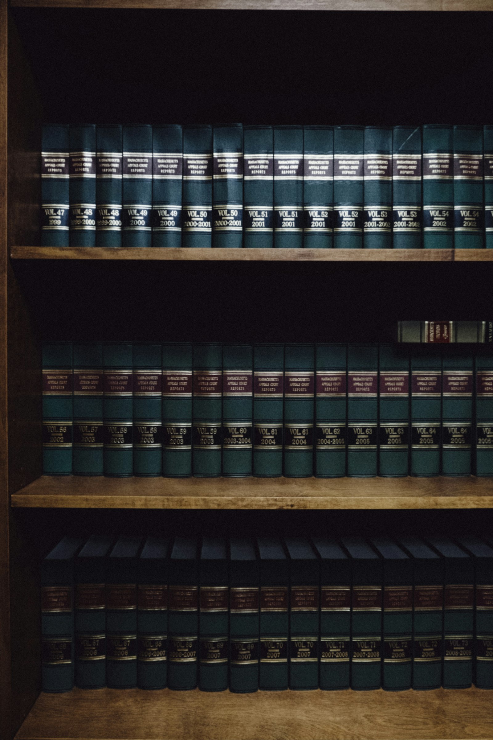 Legal textbooks and bound volumes standing on a shelf